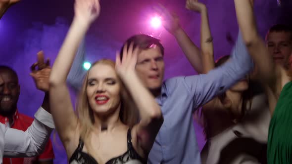 People of Different Nationalities Dancing at Party. Close-up Shift Camera alt