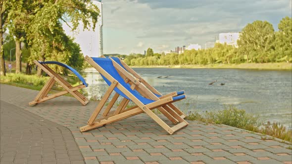 Empty Sun Loungers on the River Bank