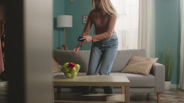 Young Girl Takes a Red Apple and a Phone