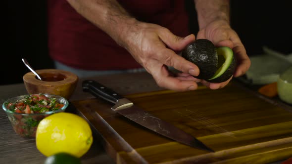 Cutting Avocado on Wood Board 