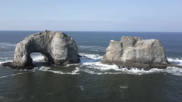 Passing between Twin rocks just off of Rockaway Beach, Oregon, aerial alt