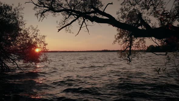 Cinematic aerial view from drone flying over Mindemoya Lake in Manitoulin, Canada at golden hour alt