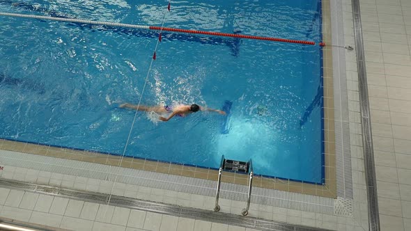 Top View of Girl Professional Swimmer Doing Freestyle and Flip Turn in the Pool