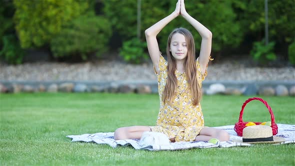 Little Girl in Yoga Position in the Park.