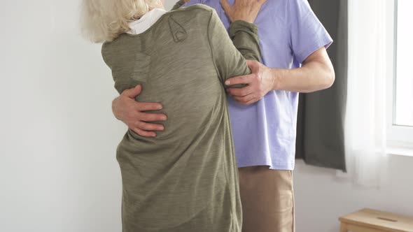 Adult Mature Couple Dancing Together in a Cozy House alt