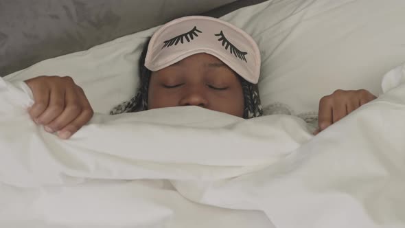 African American Woman in Sleep Mask in Bed alt