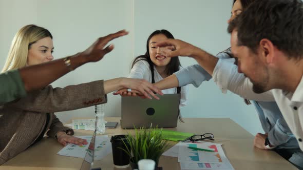 Teamwork Success Office Workers Fold Their Hands Celebrating the Launch of a New Project alt