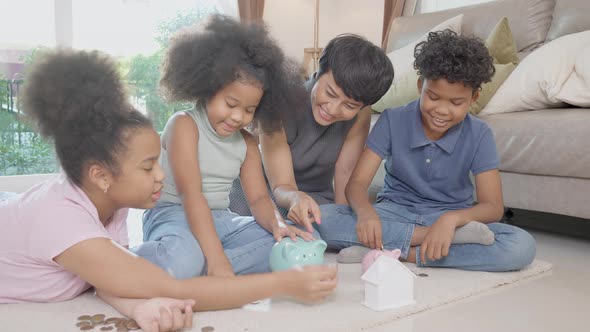 Happiness African family with mother and children saving money in piggy bank for planning future. alt