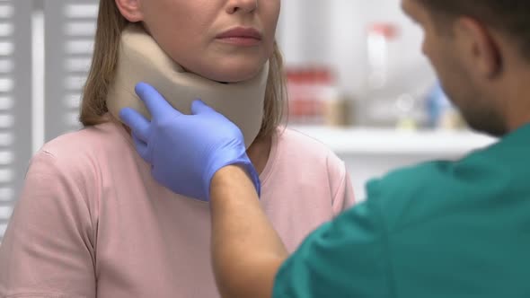 Traumatologist Examination of Female Patient With Foam Cervical Collar, Injury