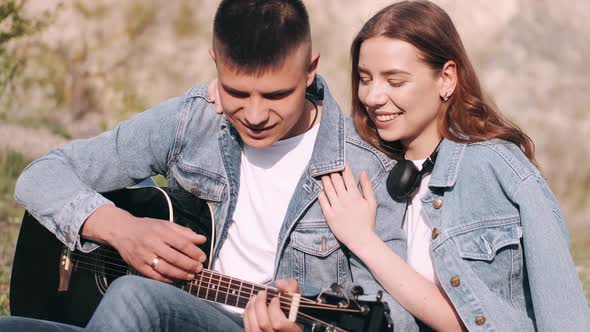 Man Plays Song for Girlfriend on Romantic Date in Forest alt