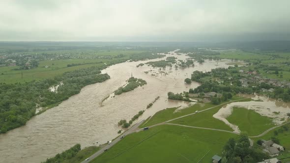 Aerial View of the Overflowing River. Flooded Buildings and Roads. Extremely High Water Level in the