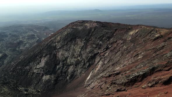 a red volcano overlooking the frozen lava