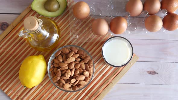 Almond Nut Egg Oil and Milk on Table alt