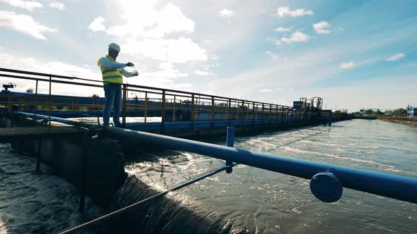 Wastewater Operator Taking Water Samples at a Sewage Cleaning Plant alt