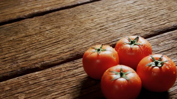 Fresh tomatoes on wooden table 4k alt