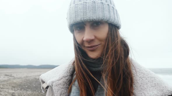 Close-up Portrait of Beautiful Happy Female Tourist Smiling at Camera, Posing at Cold Windy Winter alt