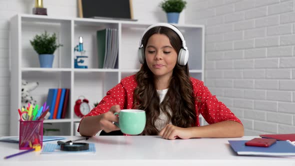 Cheerful Teen Girl in Headphones Drinking Tea From Cup Childhood