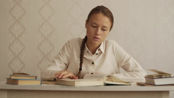 Young woman quickly flips through the book looking for right page. Education. Reading a book Library alt