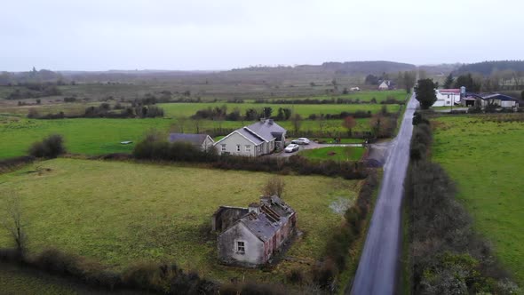 Aerial - Main road of a downtown nearby the river and the cafe on the roadside. alt