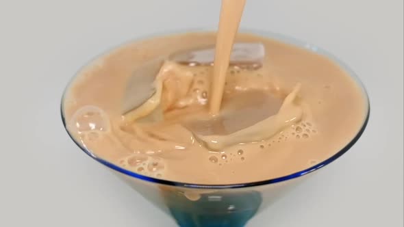 Iced Coffee - Pouring Latte On Ice Cubes