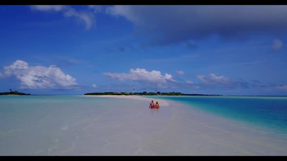 Man and woman happy together on relaxing bay beach journey by blue water and white sandy background  alt