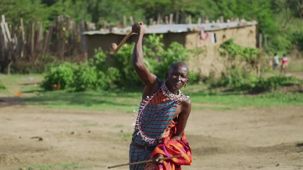 Maasai man throwing a rungu alt