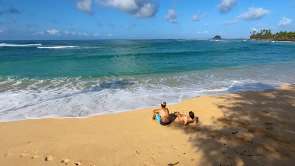Boy And Girl On A Sandy Tropical Beach