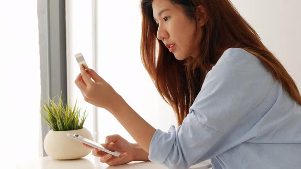 Beautiful woman shopping online with a credit card.