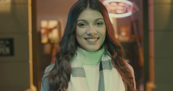 Beautiful young woman posing in the city street