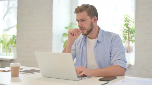 Young Creative Man with Laptop Having Coughing in Modern Office alt