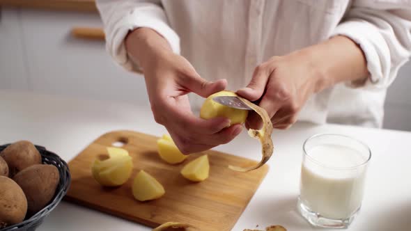 Cook White Girl Peeling Potatoes For Cooking Vegetable Food Woman Preparing Milk From Potatoes alt