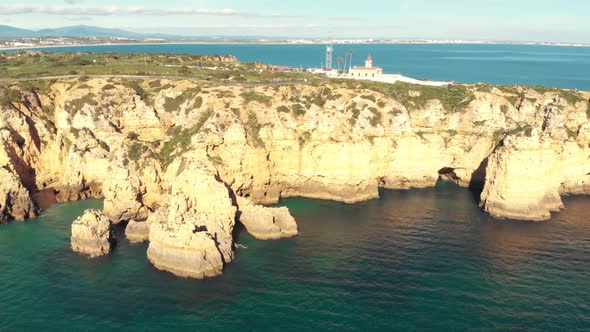 Ponta da Piedade limestone coastline and lighthouse over clifftop, Lagos, Algarve alt