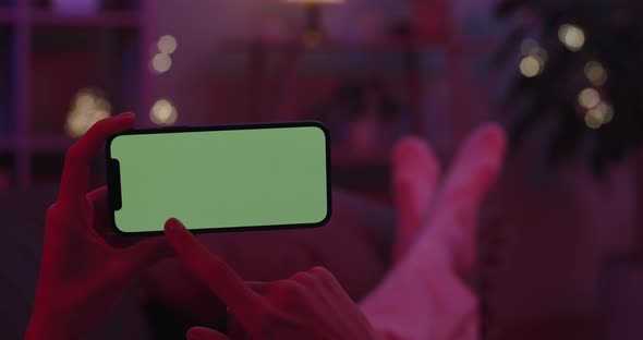 Woman Tapping on Green Screen of Modern Smartphone alt