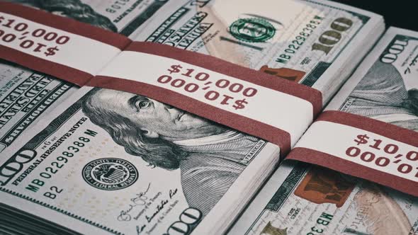 Three Stacks of 10000 American Dollars Banknotes in Bank Packs are Spin alt