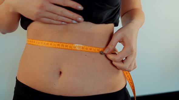 Woman Measuring Waist Progress Weight Loss. Checking Body With Measure Tape. Progress On Dieting alt