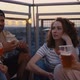 Group of friends have a party on evening in top of the roof. Shot with RED helium camera in 8K. - VideoHive Item for Sale