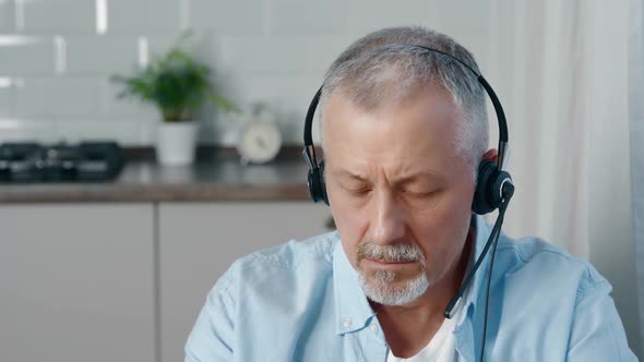 A Focused Person with Headphones is Studying Online Courses Using Computer Applications