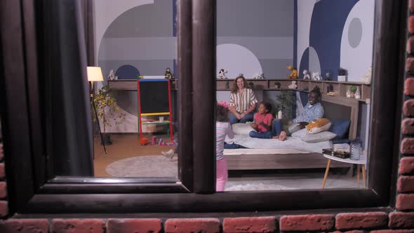 Joyful Children Playing Ball with Parents at Home alt