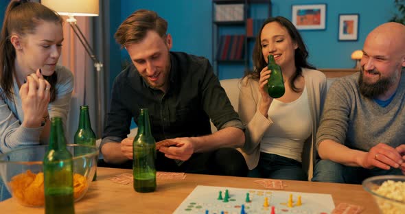 Man Dressed in Denim Shirt Sitting on Couch in Living Room with Best Friends They alt