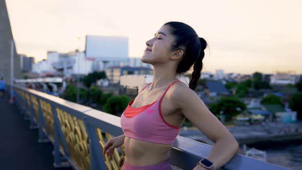 Woman Athlete Relaxing at Sunset alt
