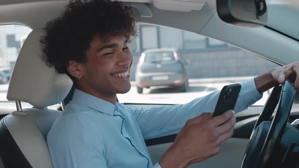 Portrait of Surprised Happy African American Black Man Reading Text Message on His Smartphone alt