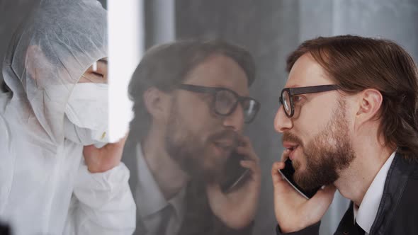 Man Communicates with a Asian Woman Through Glass, Put Their Hands To the Glass, a Quarantine Zone alt