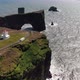Aerial shot of Dyrholaey lighthouse and lava arch near Vik i Myrdal, Iceland - VideoHive Item for Sale