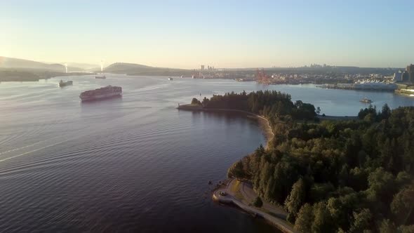 Large Cargo Ship Transporting And Sailing At The Burrard Inlet During A Bright Sunrise in Vancouver, alt