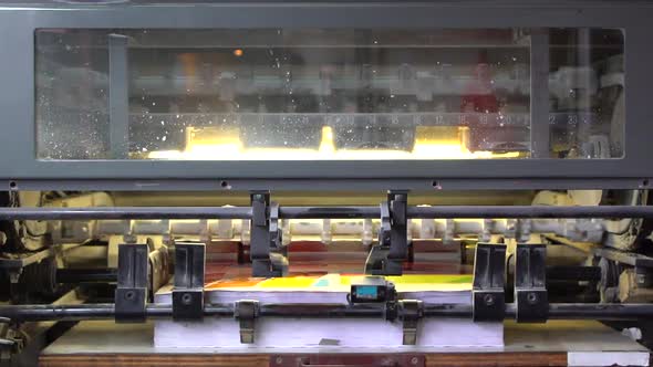 Printed Papers Coming Out Fast From a Printing Machine alt