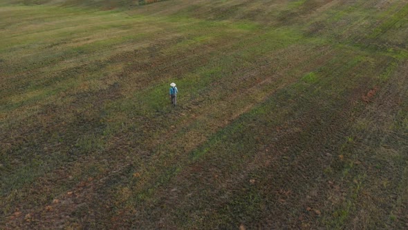 Farmer Walking in Mown Field alt