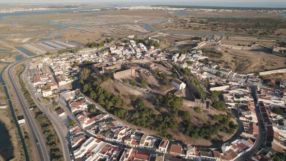 Aerial panning shot, ruins of an old fortification and castle in Castro Marim in Portugal. alt