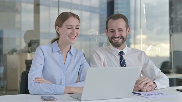 Business People Doing Video Chat on Laptop in Board Room alt