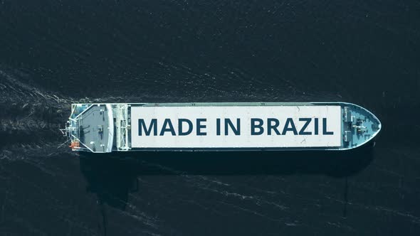Aerial View of Moving Big Cargo Ship with MADE IN BRAZIL Text alt