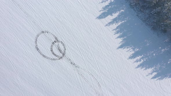 Winter tire prints in the snow 4K drone video